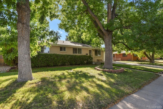 single story home featuring a front yard