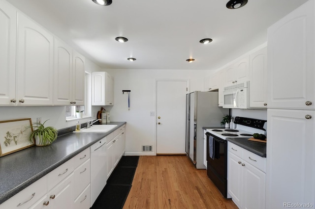 kitchen featuring sink, white appliances, white cabinets, and light wood-type flooring