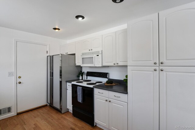 kitchen featuring electric stove, white cabinetry, light hardwood / wood-style flooring, and stainless steel refrigerator