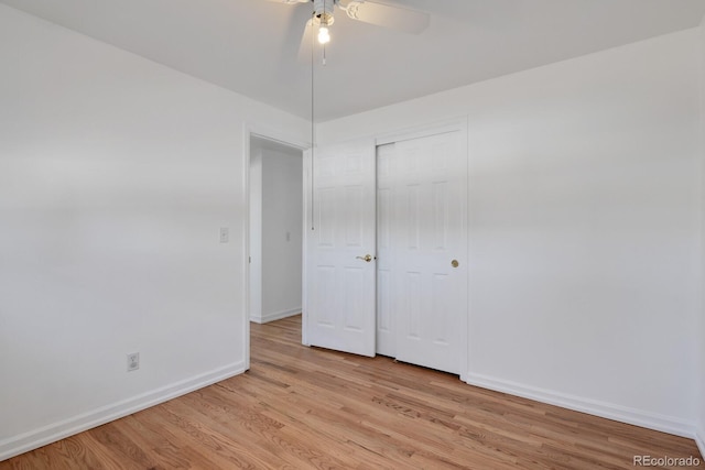 unfurnished bedroom featuring light hardwood / wood-style flooring, a closet, and ceiling fan