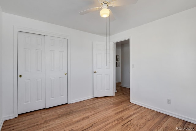 unfurnished bedroom featuring light hardwood / wood-style floors, ceiling fan, and a closet