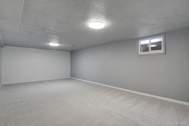 basement with carpet and a textured ceiling