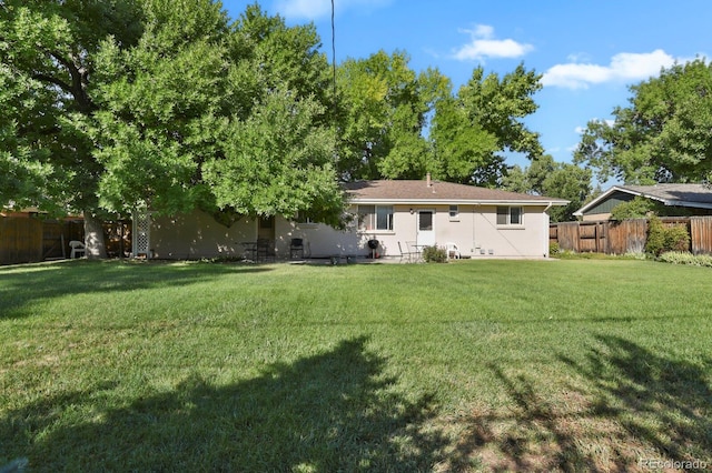 rear view of house with a yard