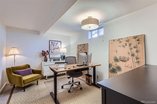 office featuring light colored carpet, baseboards, and a textured ceiling