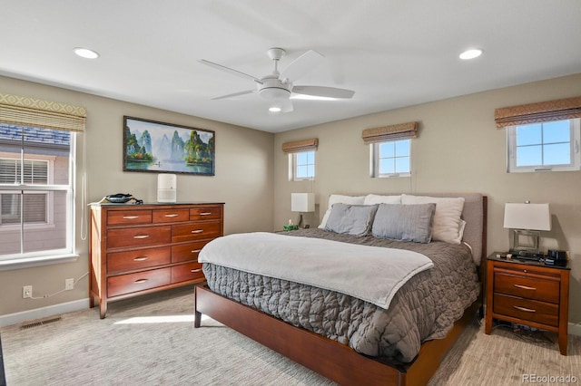 bedroom with light colored carpet and ceiling fan