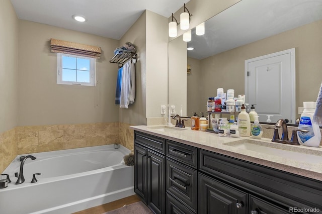 bathroom featuring a tub to relax in and vanity