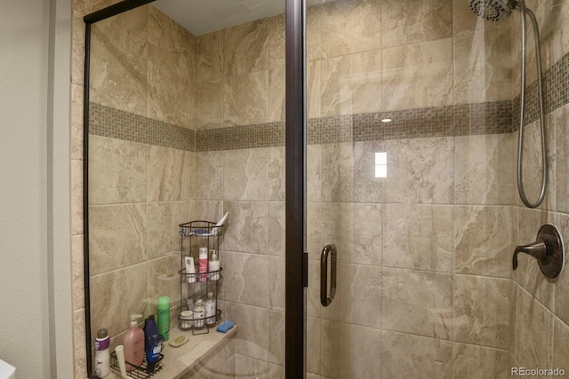 bathroom with a shower with shower door