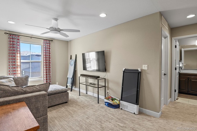 carpeted living room featuring ceiling fan