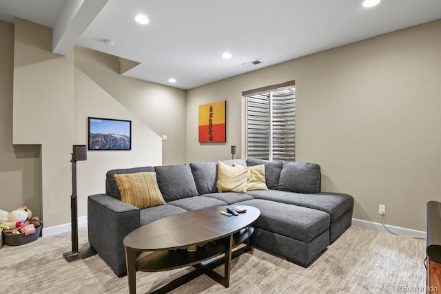 carpeted living room featuring beamed ceiling