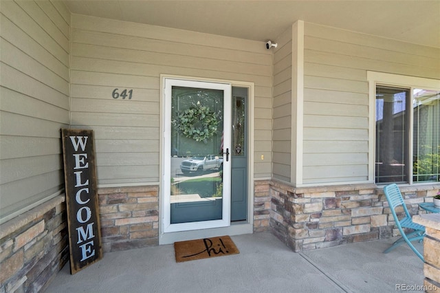 641 Denali Ct, Windsor, CO 80550 - property entrance with stone siding and a security system