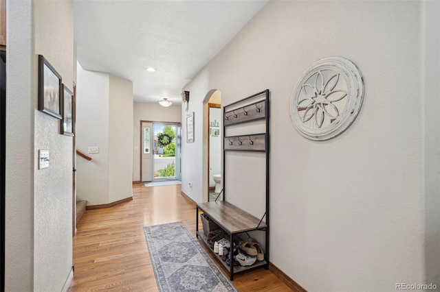 641 Denali Ct, Windsor, CO 80550 - hallway with arched walkways, light wood-style flooring, baseboards, and recessed lighting