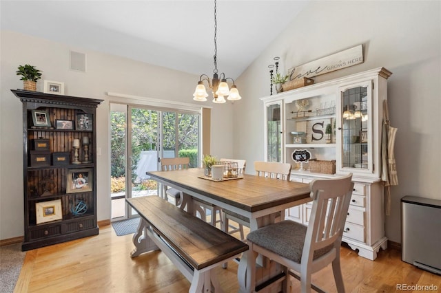 641 Denali Ct, Windsor, CO 80550 - dining room with a chandelier, vaulted ceiling, and light wood-type flooring