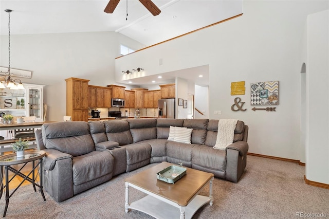 641 Denali Ct, Windsor, CO 80550 - living room featuring ceiling fan, baseboards, high vaulted ceiling, light colored carpet, and arched walkways