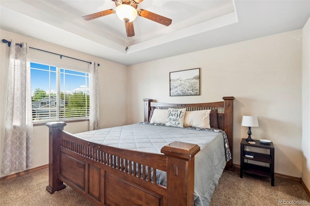 641 Denali Ct, Windsor, CO 80550 - bedroom featuring baseboards, light colored carpet, a tray ceiling, and ceiling fan