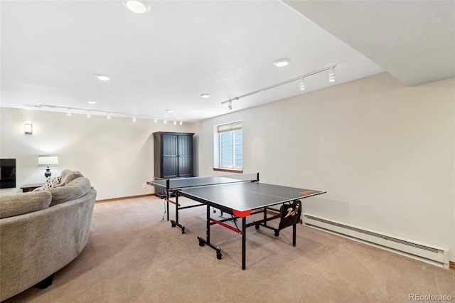 641 Denali Ct, Windsor, CO 80550 - rec room featuring track lighting, a baseboard radiator, light colored carpet, and baseboards