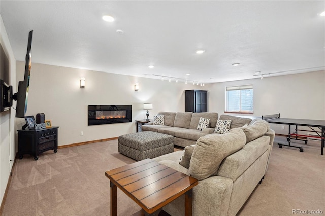 641 Denali Ct, Windsor, CO 80550 - living room featuring light colored carpet, a glass covered fireplace, recessed lighting, and baseboards