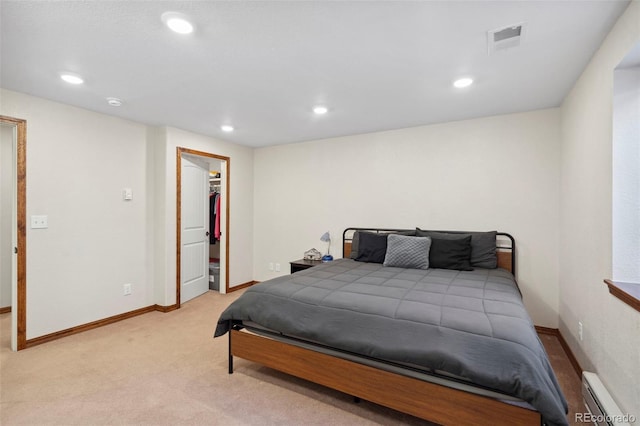 641 Denali Ct, Windsor, CO 80550 - bedroom with a baseboard heating unit, a spacious closet, recessed lighting, light carpet, and baseboards