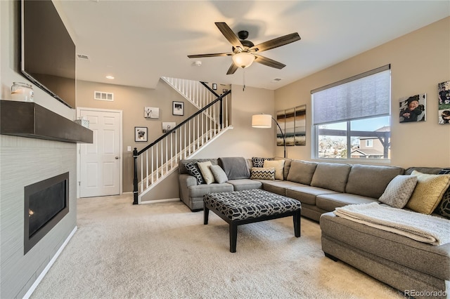 carpeted living room featuring ceiling fan