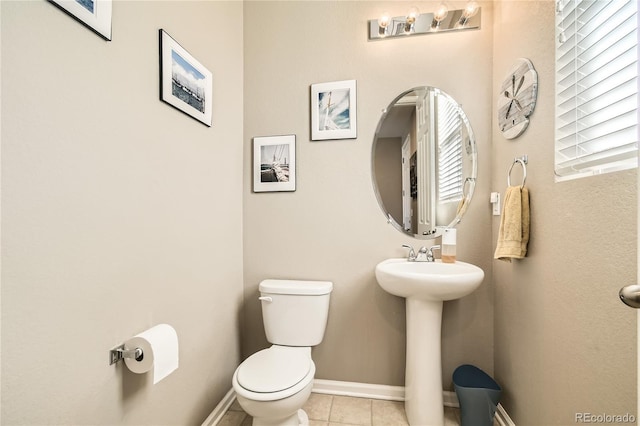 bathroom with tile patterned flooring, toilet, and sink