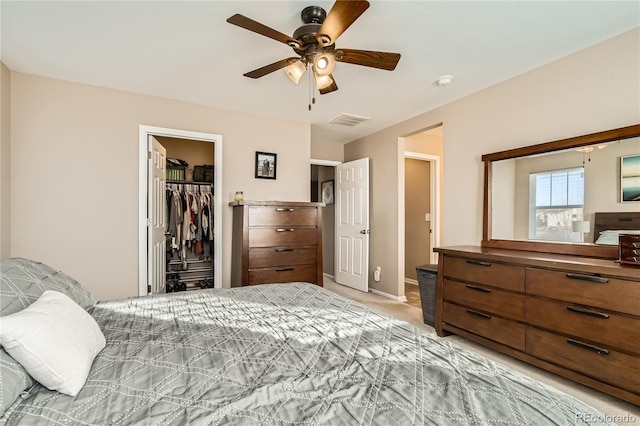 carpeted bedroom with a closet, a spacious closet, and ceiling fan