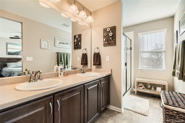 bathroom with ceiling fan, a shower with shower door, and vanity