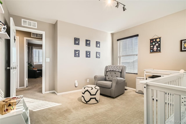 carpeted bedroom featuring a crib