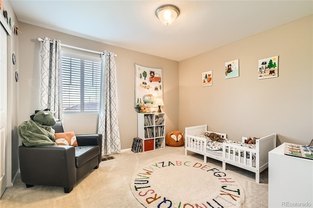 carpeted bedroom with a nursery area