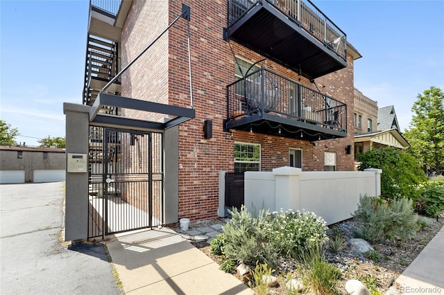 529 N Washington St Unit 304, Denver, CO 80203 - exterior space featuring a balcony, a gate, and brick siding