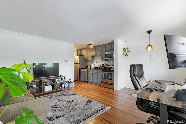 529 N Washington St Unit 304, Denver, CO 80203 - living room featuring crown molding, a desk, light wood finished floors, and a textured ceiling