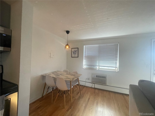 529 N Washington St Unit 304, Denver, CO 80203 - dining space featuring ornamental molding, a baseboard radiator, wood finished floors, and a wall unit AC