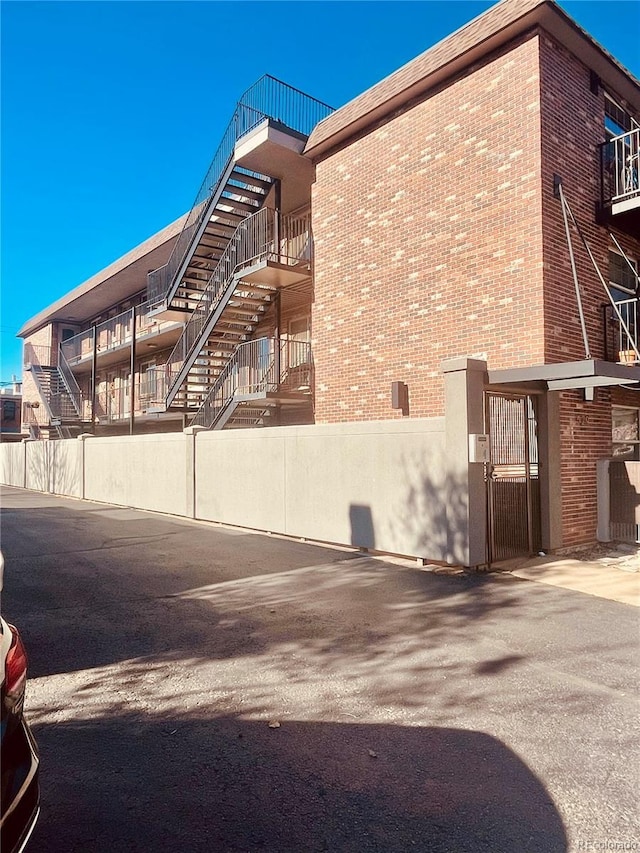 529 N Washington St Unit 304, Denver, CO 80203 - view of property exterior with brick siding and a gate