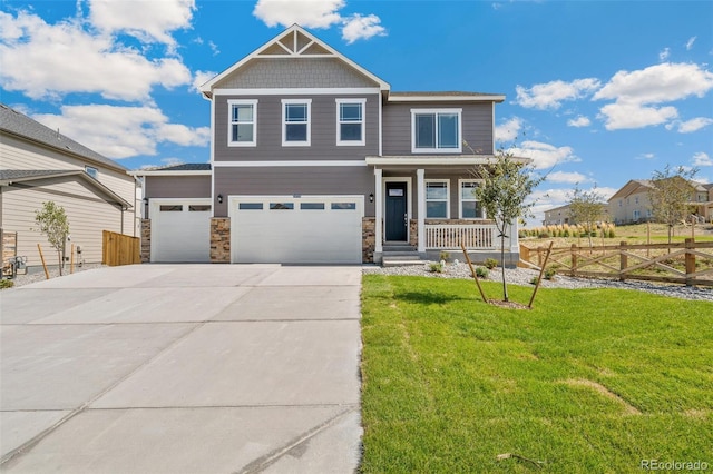 craftsman-style home with a garage, a front yard, and a porch