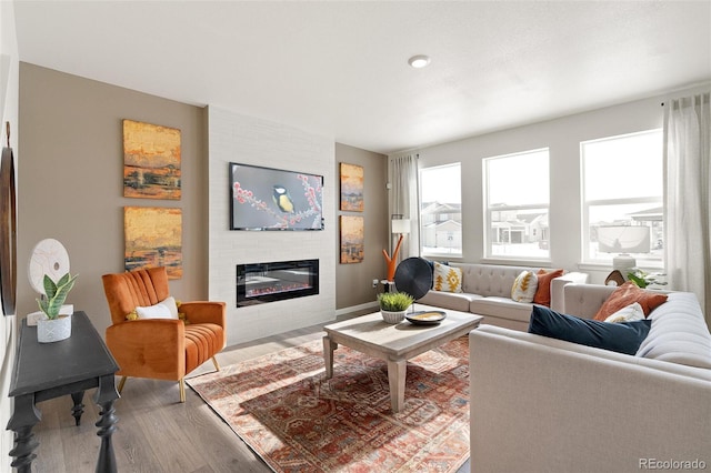 living area with wood finished floors and a fireplace
