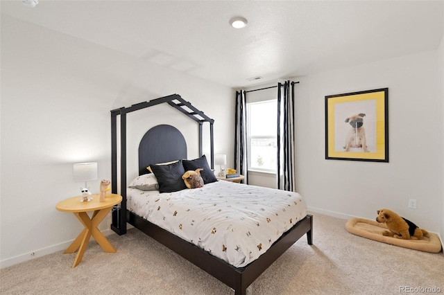bedroom featuring light carpet and baseboards