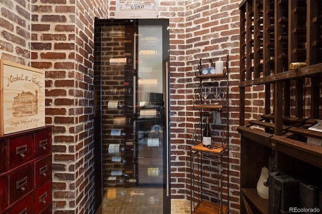 wine area featuring brick wall