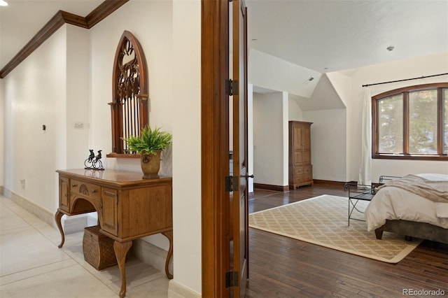 bedroom with hardwood / wood-style flooring, lofted ceiling, and ornamental molding