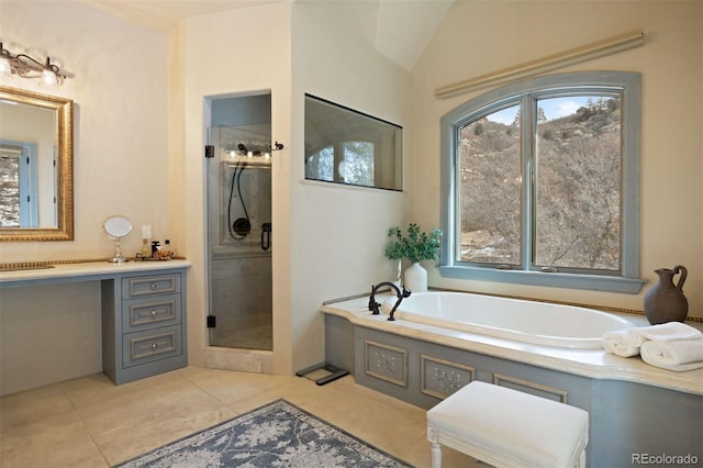 bathroom featuring plus walk in shower, vanity, and tile patterned floors