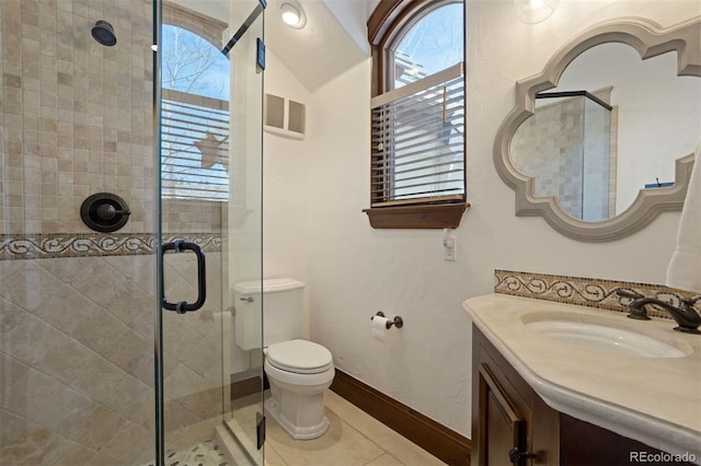 bathroom with walk in shower, vanity, toilet, and tile patterned flooring