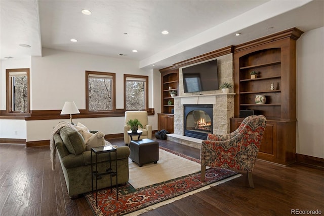 living room with dark wood-type flooring and a fireplace