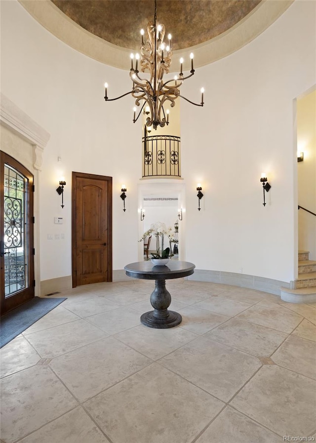 tiled foyer entrance featuring a towering ceiling