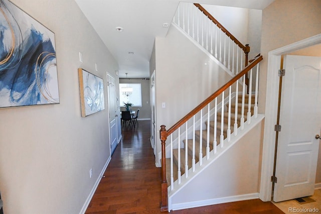 interior space featuring stairway, baseboards, and wood finished floors