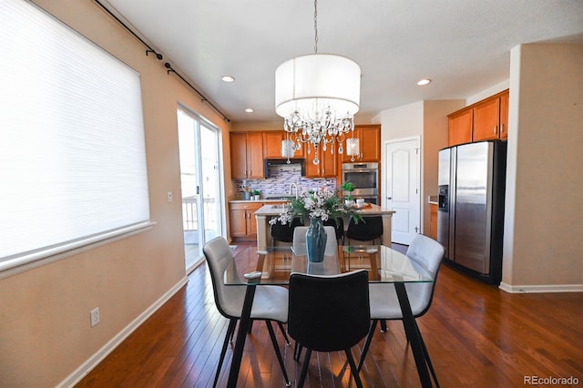 dining space with recessed lighting, a notable chandelier, dark wood finished floors, and baseboards