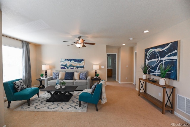 living area featuring recessed lighting, light colored carpet, visible vents, a ceiling fan, and baseboards