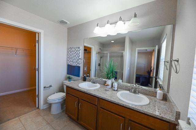 bathroom featuring a stall shower, tile patterned flooring, visible vents, and a sink