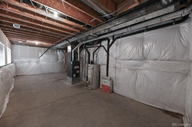 below grade area featuring heating unit and water heater