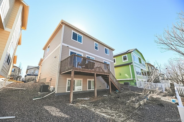 back of property featuring cooling unit, fence, stairway, and a wooden deck