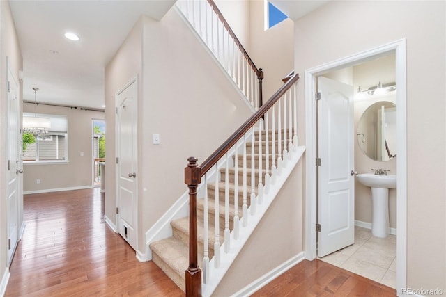 3565 E 141st Dr, Thornton, CO 80602 - stairs featuring wood finished floors and baseboards