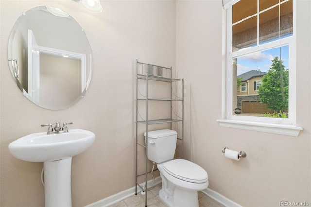 3565 E 141st Dr, Thornton, CO 80602 - bathroom featuring baseboards, toilet, tile patterned floors, and a sink