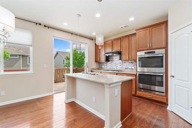3565 E 141st Dr, Thornton, CO 80602 - kitchen featuring stainless steel double oven, a sink, dark wood-type flooring, gas cooktop, and recessed lighting