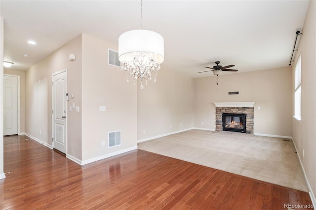 3565 E 141st Dr, Thornton, CO 80602 - unfurnished living room with ceiling fan, wood finished floors, baseboards, a stone fireplace, and recessed lighting